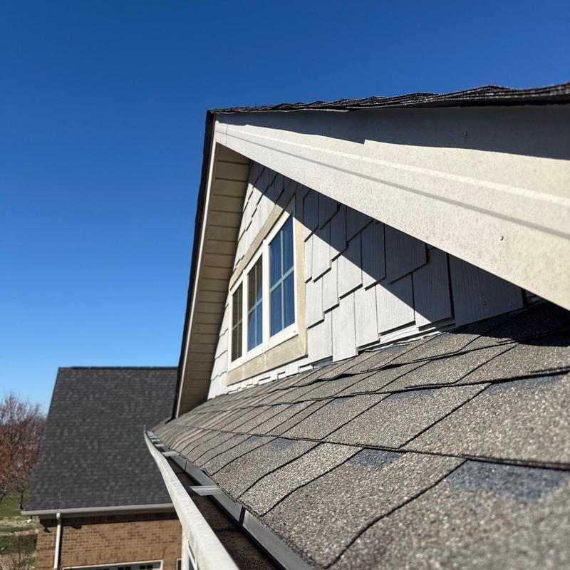 Asphalt shingle roof with gutter and window trim