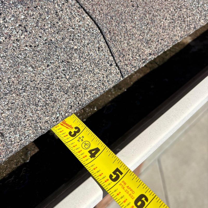 Gutter and roof edge with measuring tape