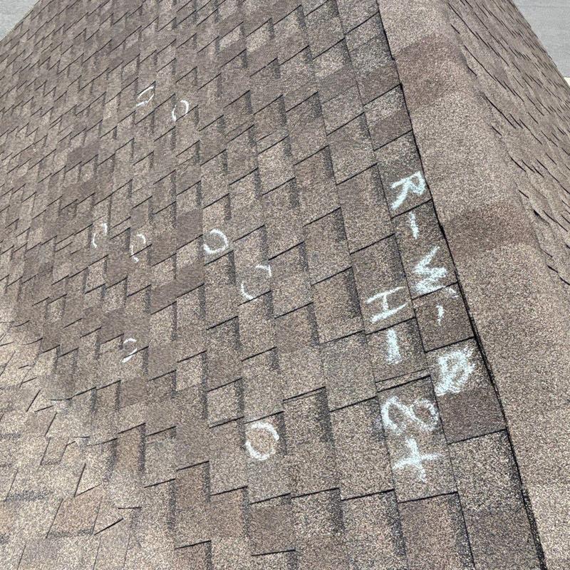Asphalt shingle roof with hail damage marking
