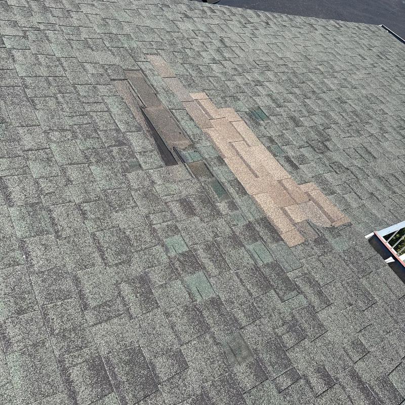 Asphalt roof shingles with hail damage and patch repairs