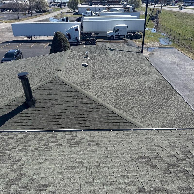 Asphalt shingle roof with vent pipes and metal flashing