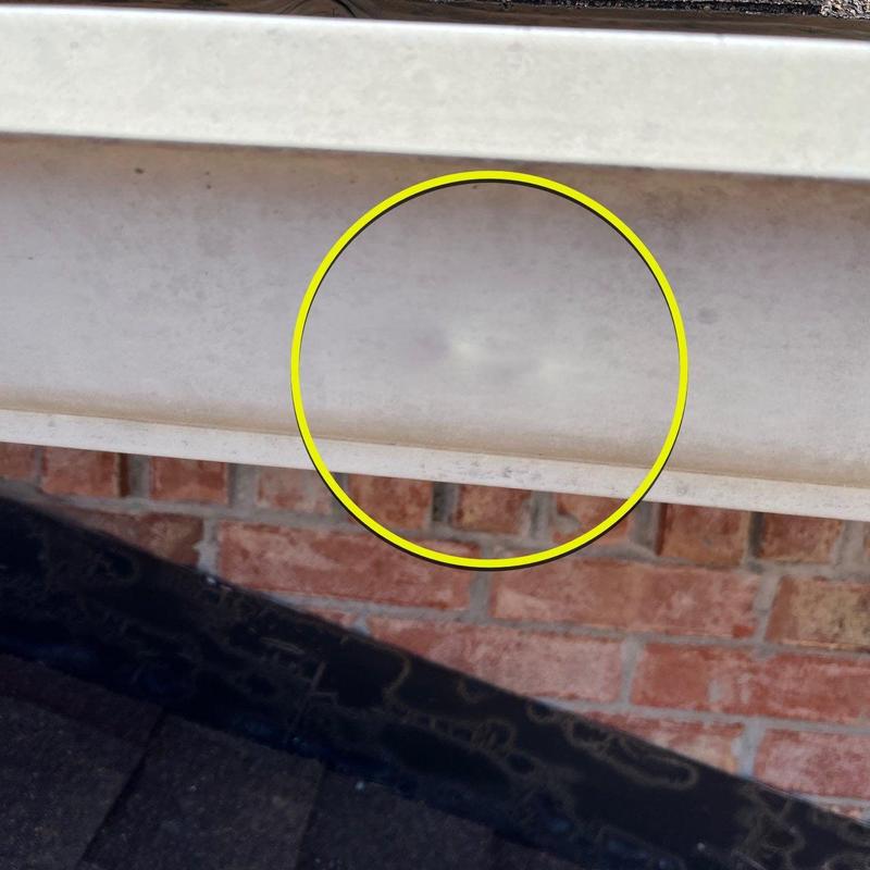 Gutter with dented area highlighted in yellow circle