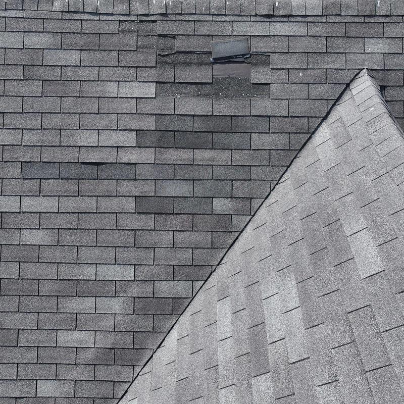Asphalt shingle roof with damaged shingle and flashing seal