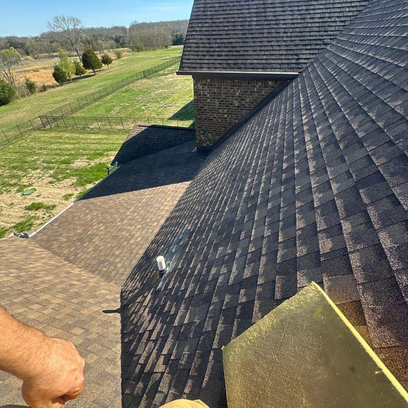 Asphalt shingle roof with visible hail damage and vent pipe