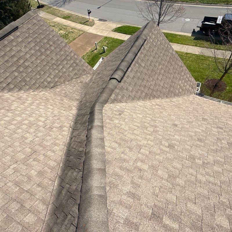 Asphalt shingle roof ridge cap and drainage inspection
