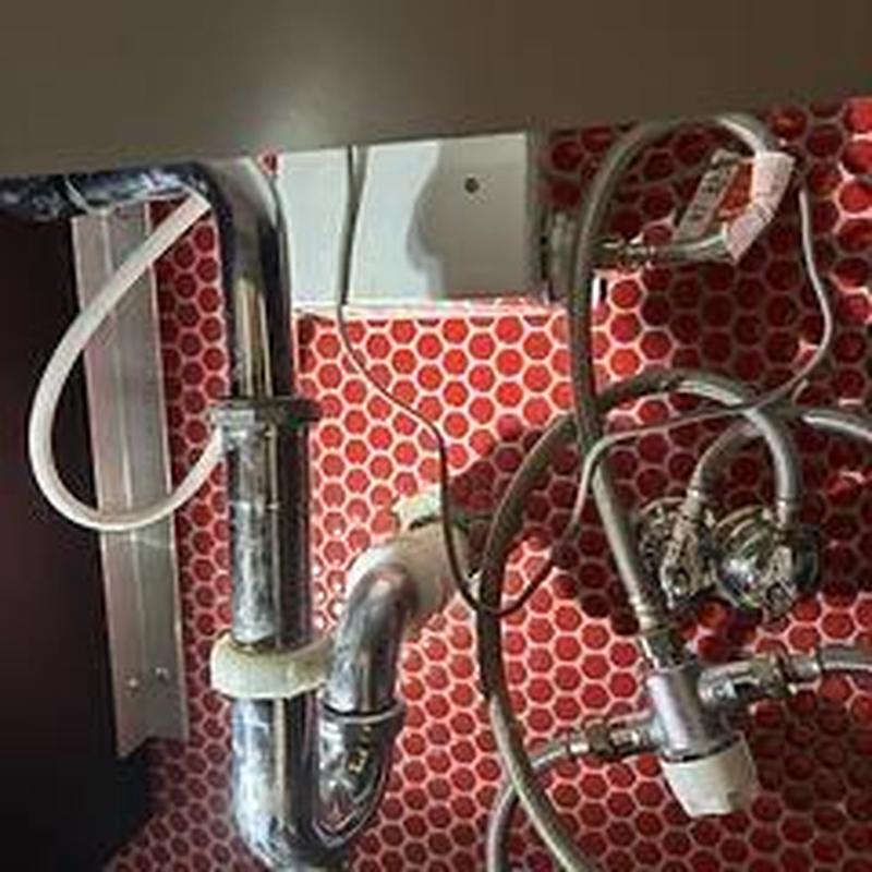 Mixing valve and water supply lines under lavatory sink