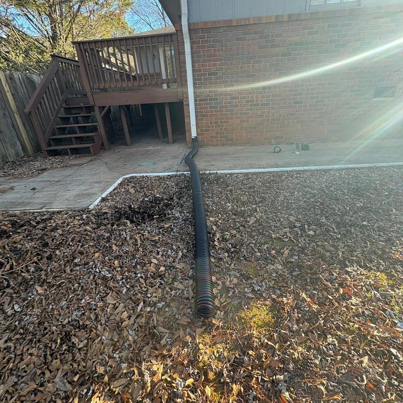 Downspout extension installed at house exterior