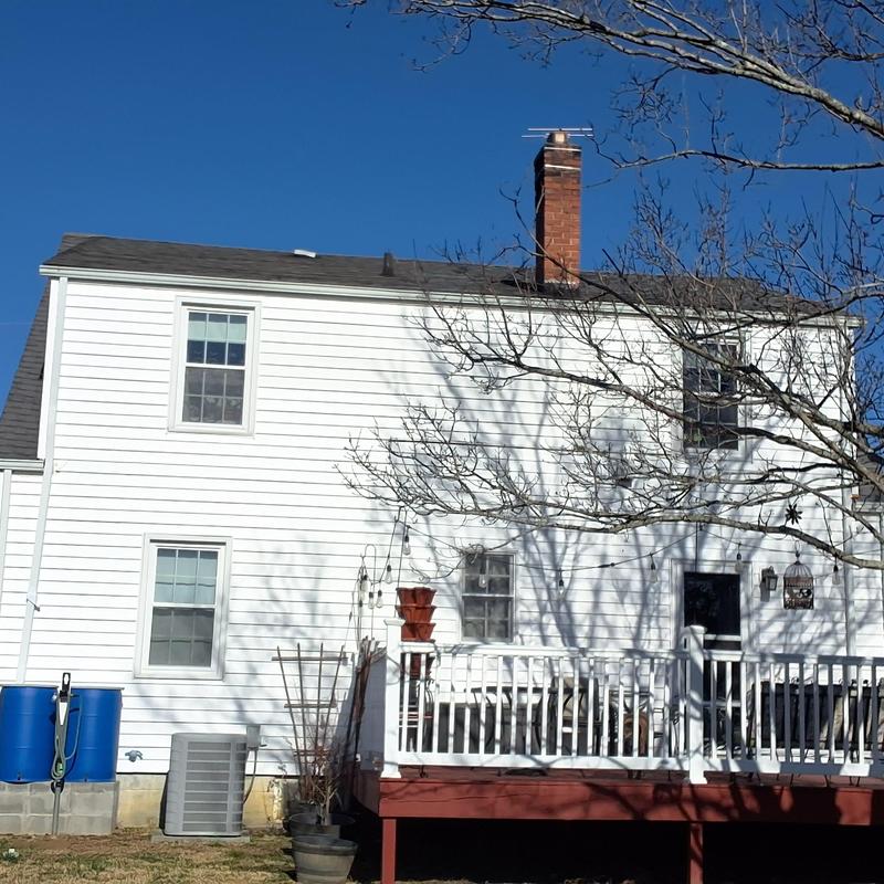 Asphalt shingle roof and chimney on two-story home