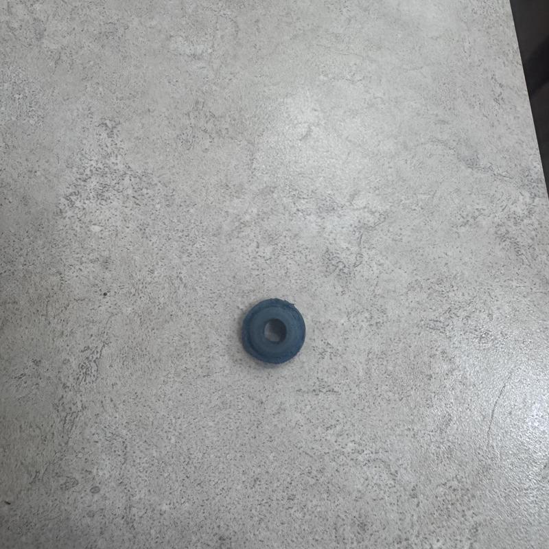 Bathtub faucet washer on textured countertop surface