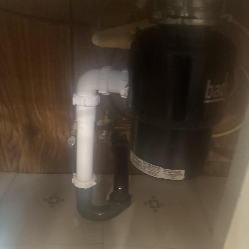 Kitchen sink drain and garbage disposal plumbing under cabinet