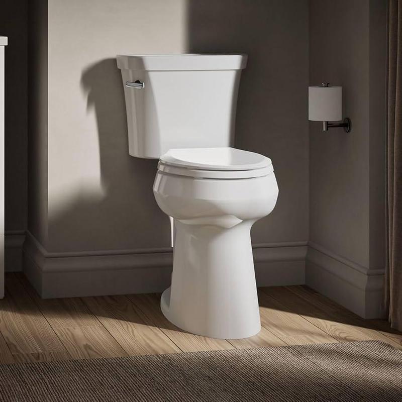 Toilet with tank and seat in bathroom corner