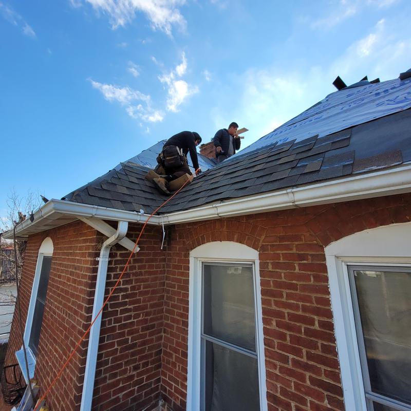 Asphalt shingle roof installation on brick home