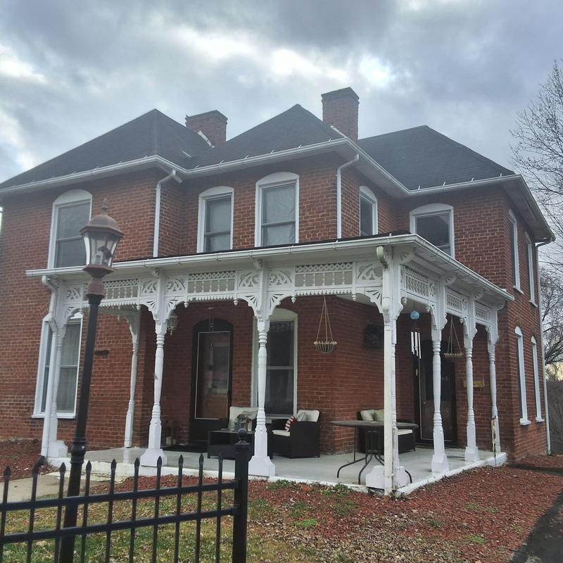 Roof shingles on two-story brick home