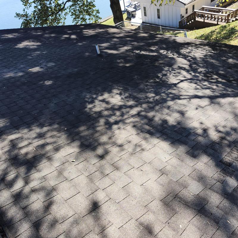Asphalt shingle roof with vent pipe near lakeview home