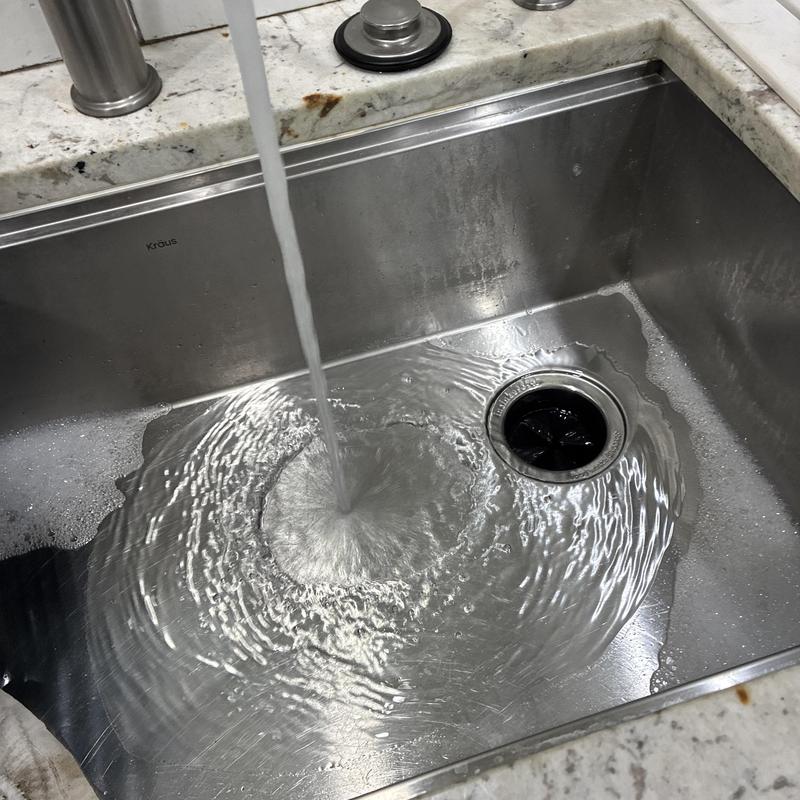 Kitchen sink drain clearing with running water test