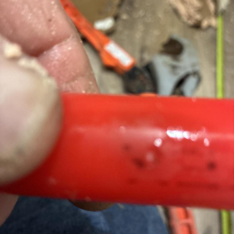 PEX piping with staple pinhole damage close-up