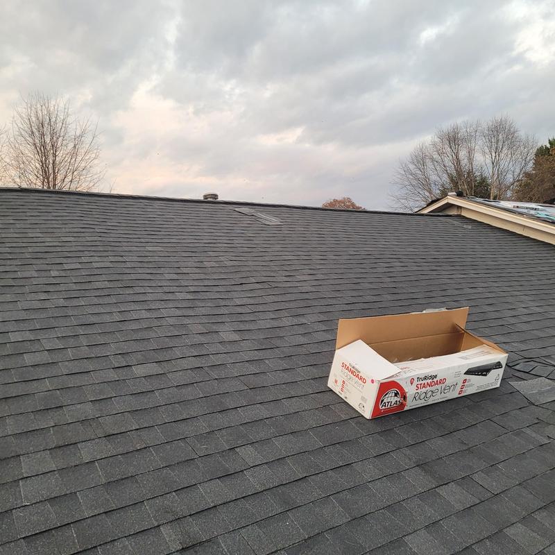 Asphalt shingle roof with ridge vent box on top