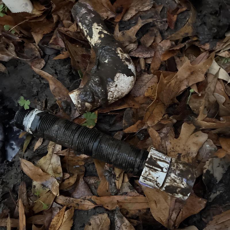 Outdoor faucet disconnected metal pipe underground dirt leaves