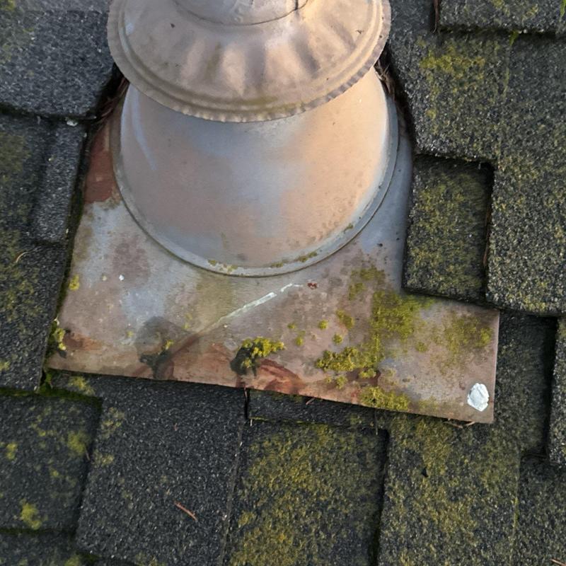 Roof vent flashing with moss and shingle wear