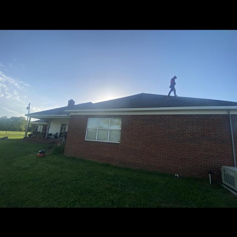 Architectural shingle roof with roofer walking on top