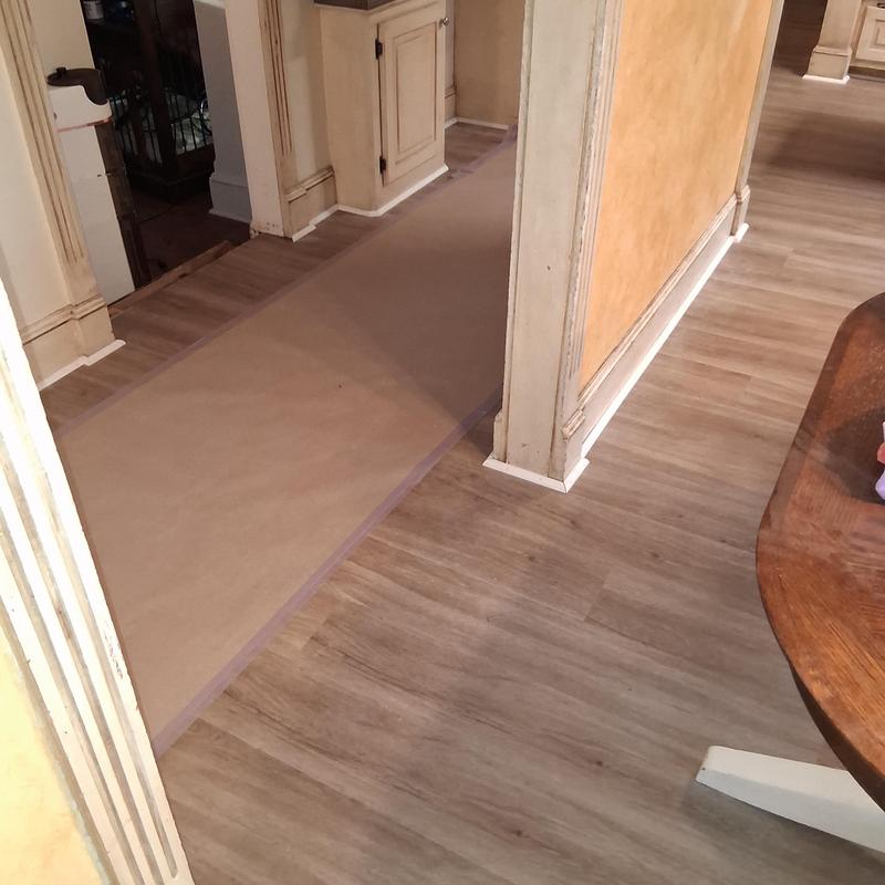 Vinyl flooring and white shoe moulding installation