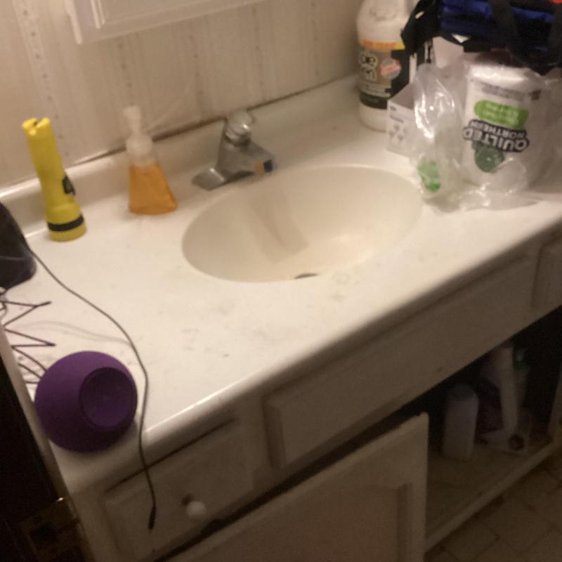 Bathroom vanity sink drain clearing with drain machine