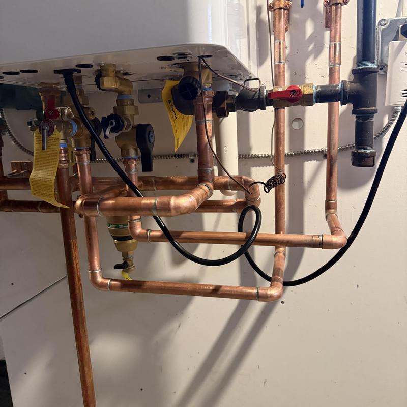 Gas boiler with copper piping installation in basement