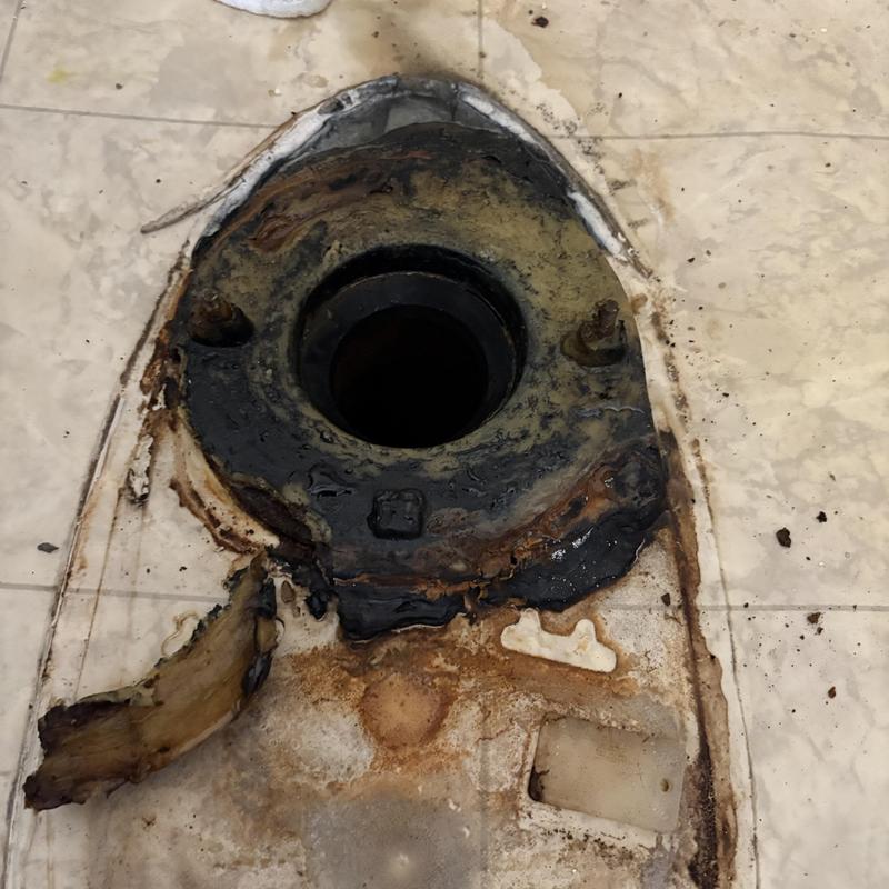 Toilet flange with old wax ring and rust damage