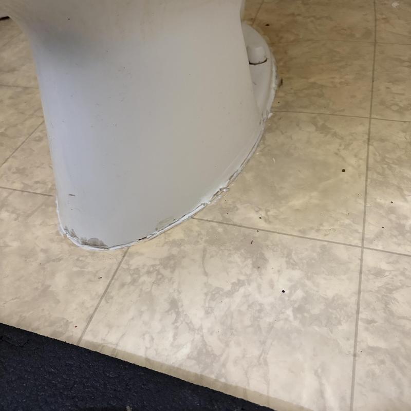Toilet base sealing on tiled bathroom floor