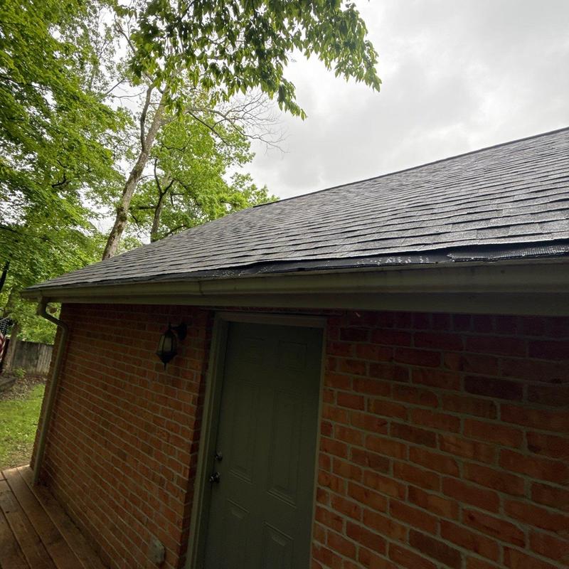 Asphalt shingles with hail damage on roof edge