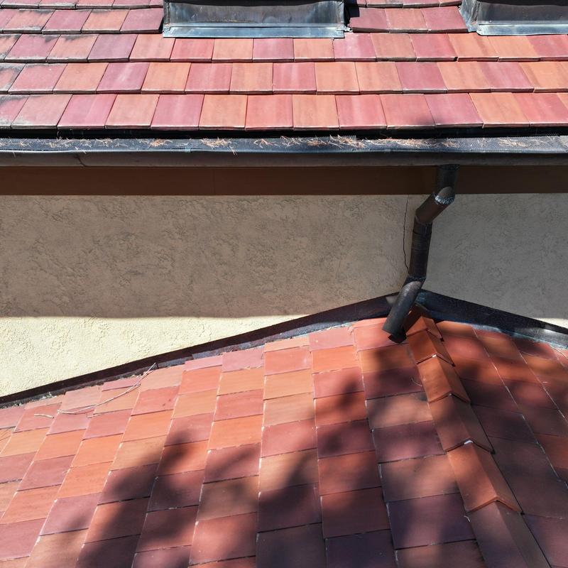 Clay tile roof with gutter and downspout system