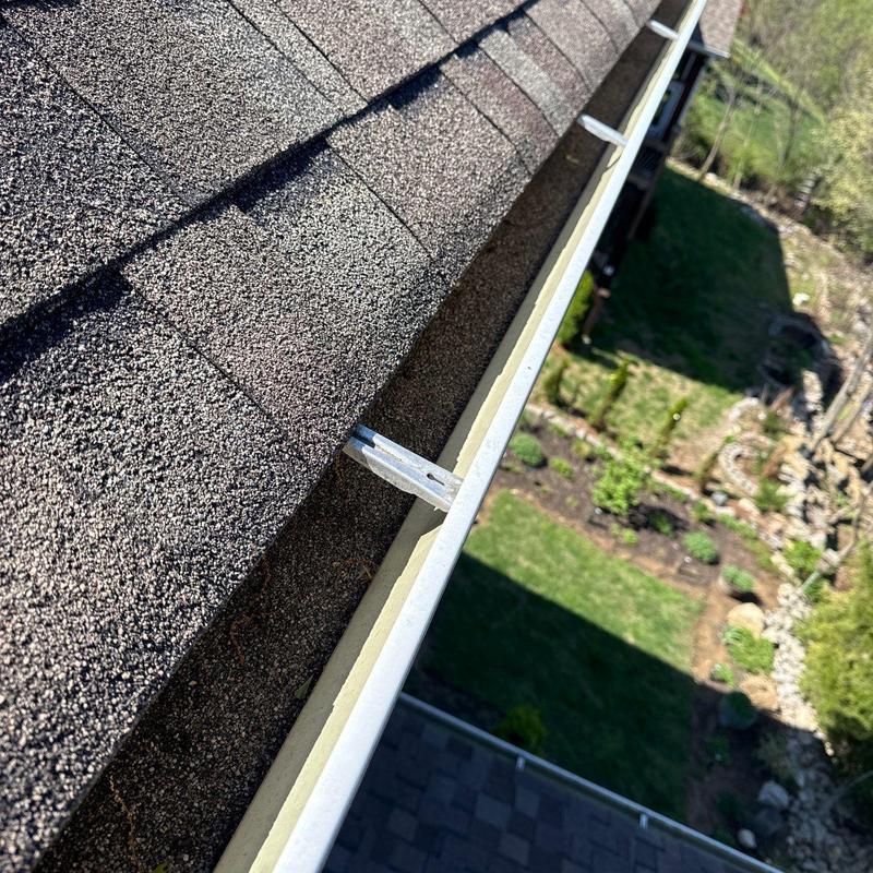 Asphalt shingle roof with attached gutter system