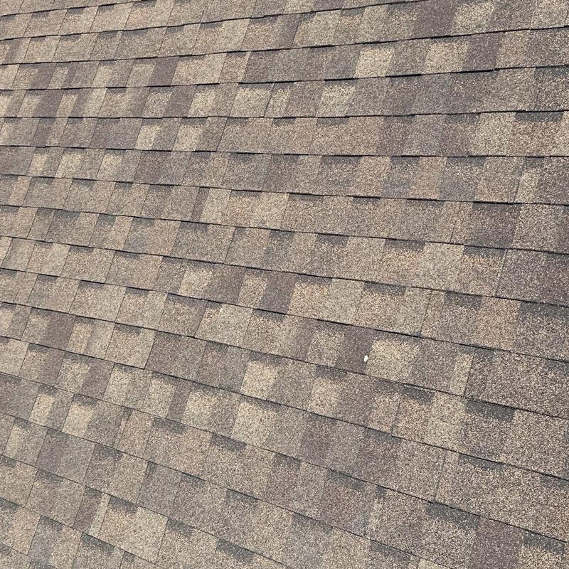 Architectural asphalt shingles with hail damage marks