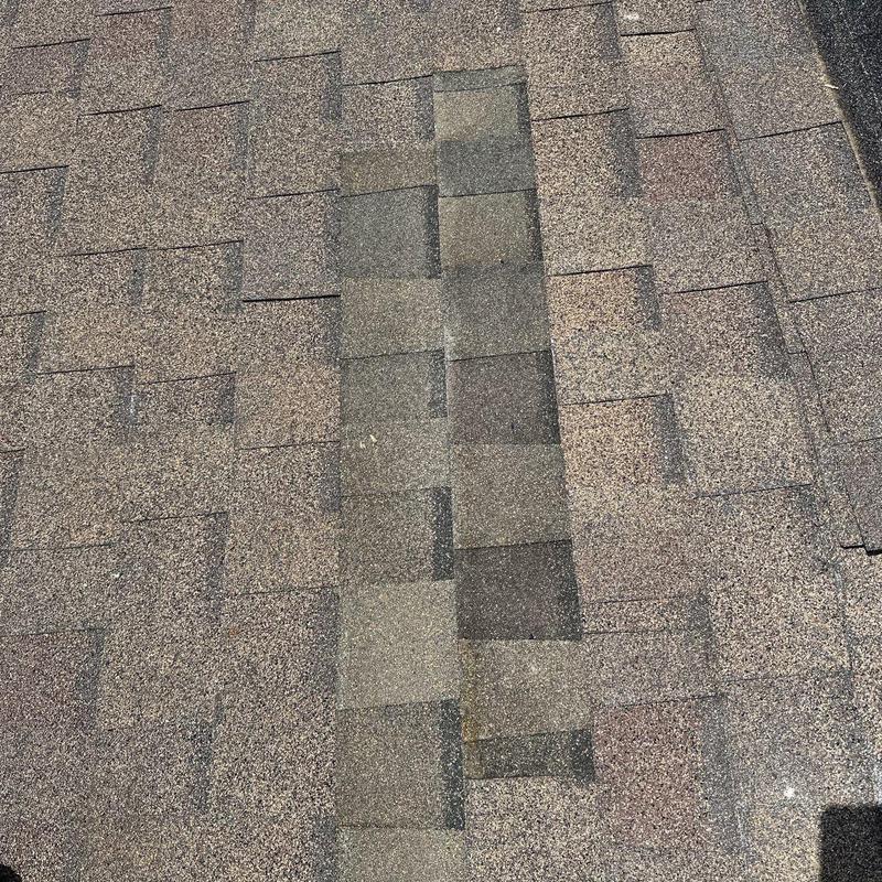 Asphalt shingle roof showing hail damage marks