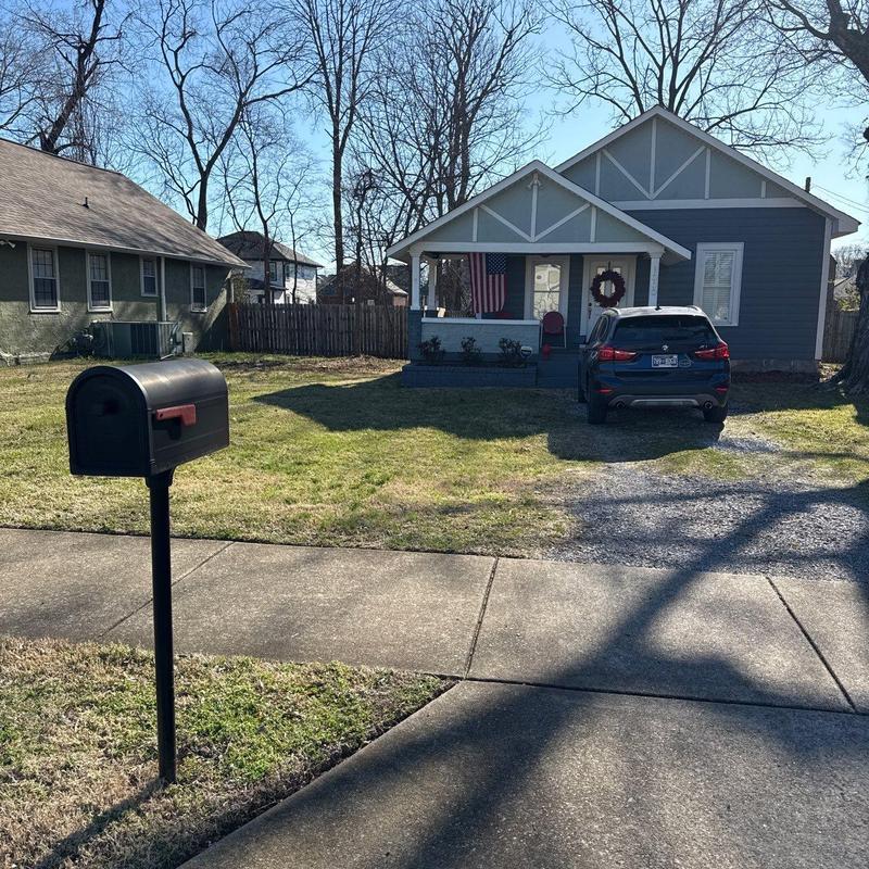 Mailbox installation on residential lawn with sidewalk