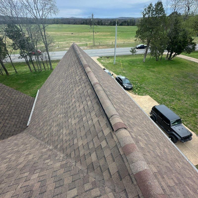 Asphalt shingle roof ridge with hail damage inspection