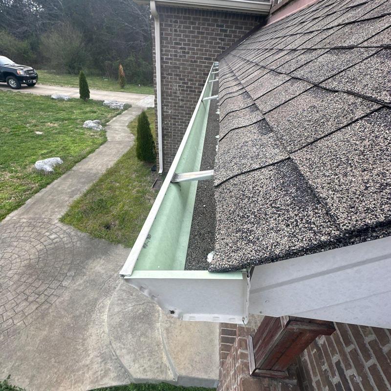 Roof shingles and rain gutter inspection with damage signs