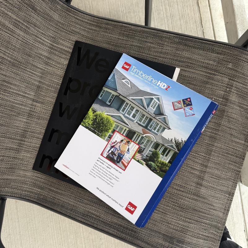 GAF Timberline HDZ roofing shingles literature on chair GAF Timberline HDZ roofing shingles literature on chair