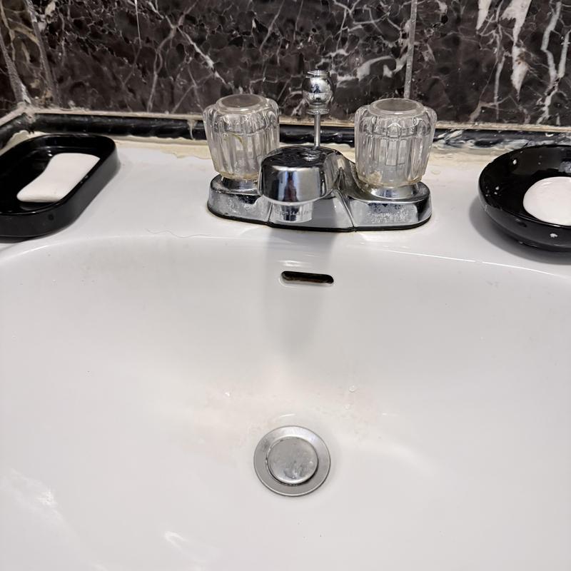 Upstairs bathroom faucet with dual clear knobs