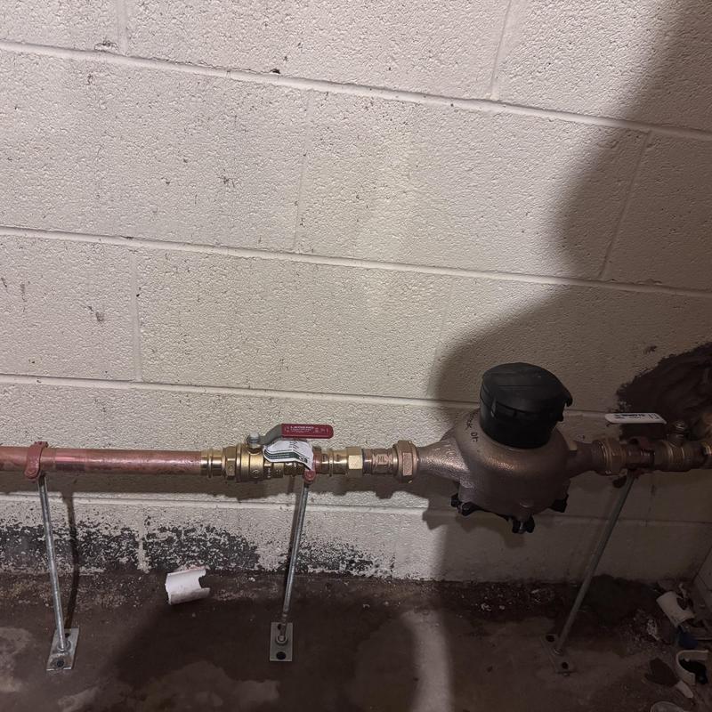 Water meter installation with copper piping and fittings