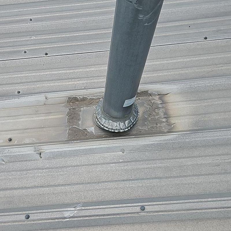 Pipe base seal on metal roof with silicone patch Pipe base seal on metal roof with silicone patch