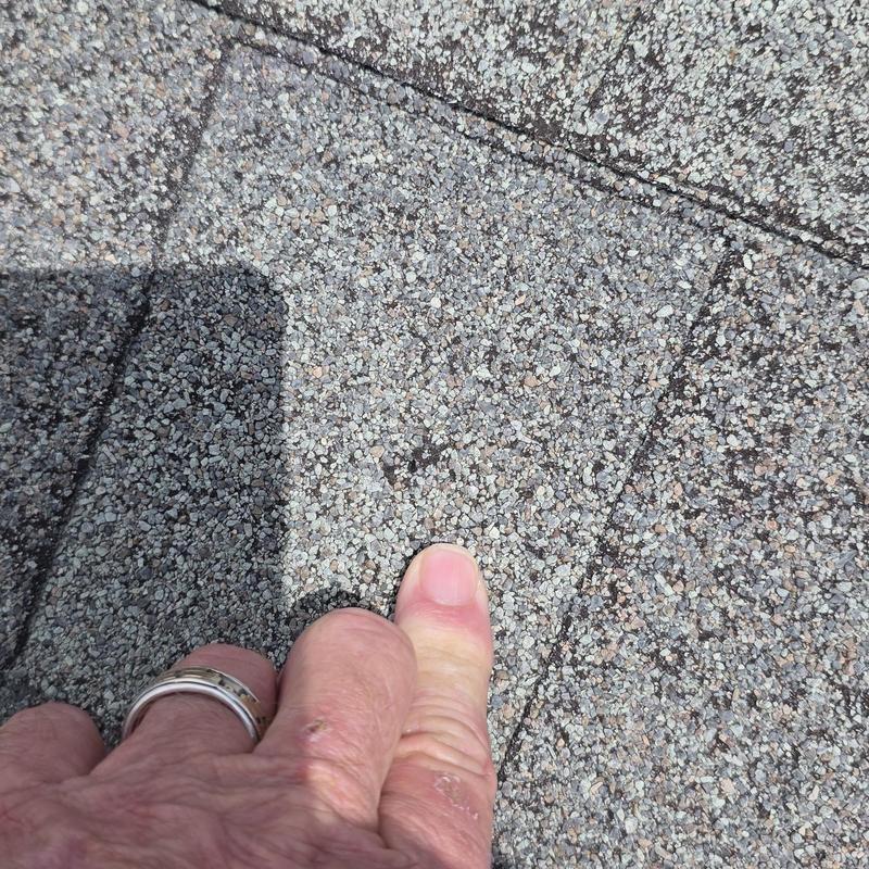Asphalt roof shingle showing hail damage close-up