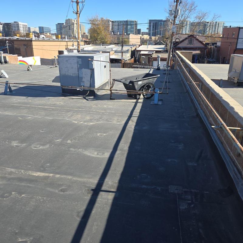 EPDM flat roof with HVAC unit and resealed edges EPDM flat roof with HVAC unit and resealed edges