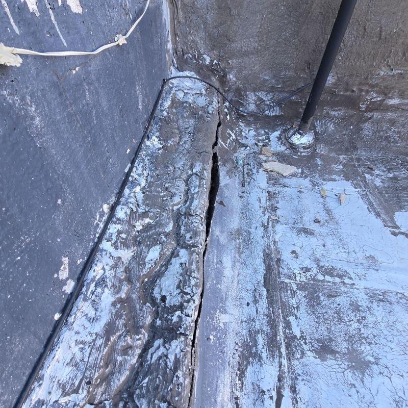 Modified bitumen roof seam with visible crack Modified bitumen roof seam with visible crack