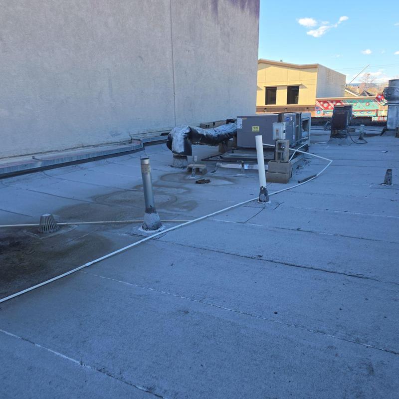 Flat TPO roof with HVAC unit and vent pipes Flat TPO roof with HVAC unit and vent pipes