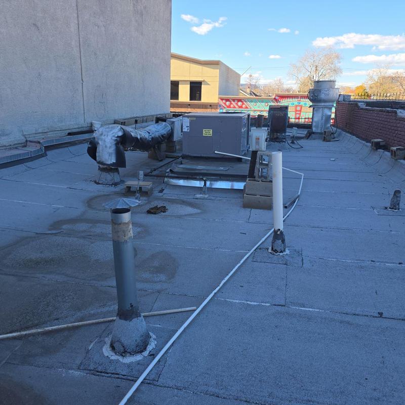 Flat TPO roof with HVAC units and ventilation pipes Flat TPO roof with HVAC units and ventilation pipes