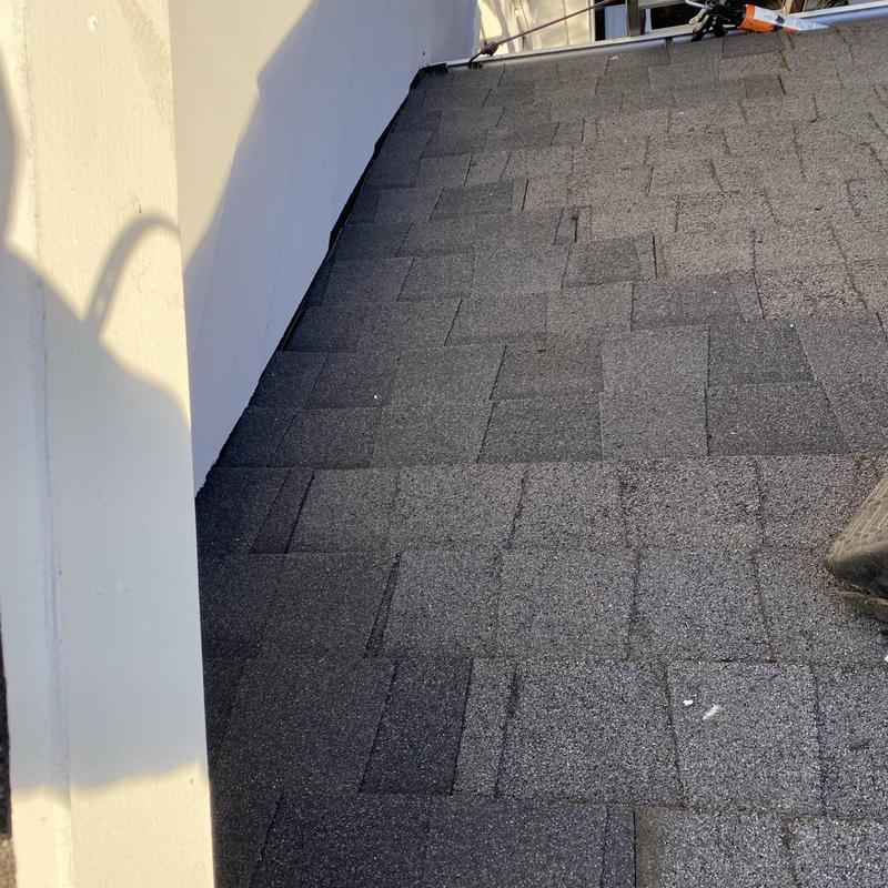 Pipe boot and step flashing on shingle roof edge