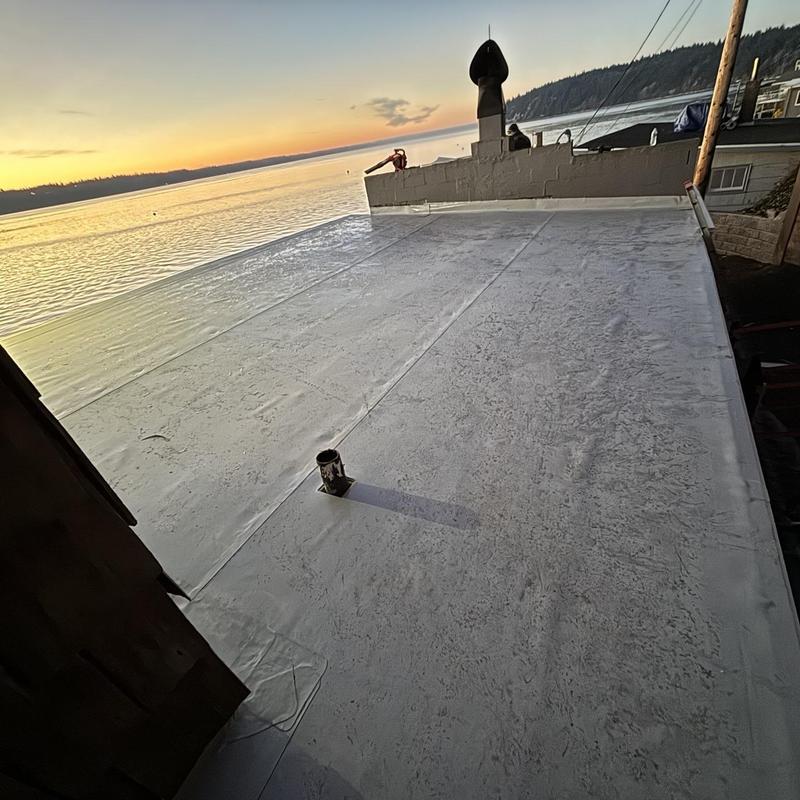 Flat roof membrane installation at waterfront property