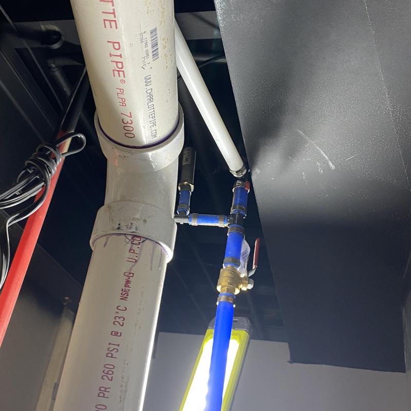 Backup sump pump water line installation beneath ceiling