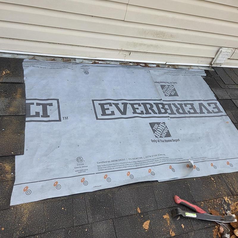 Roof decking underlayment and shingles near wall base